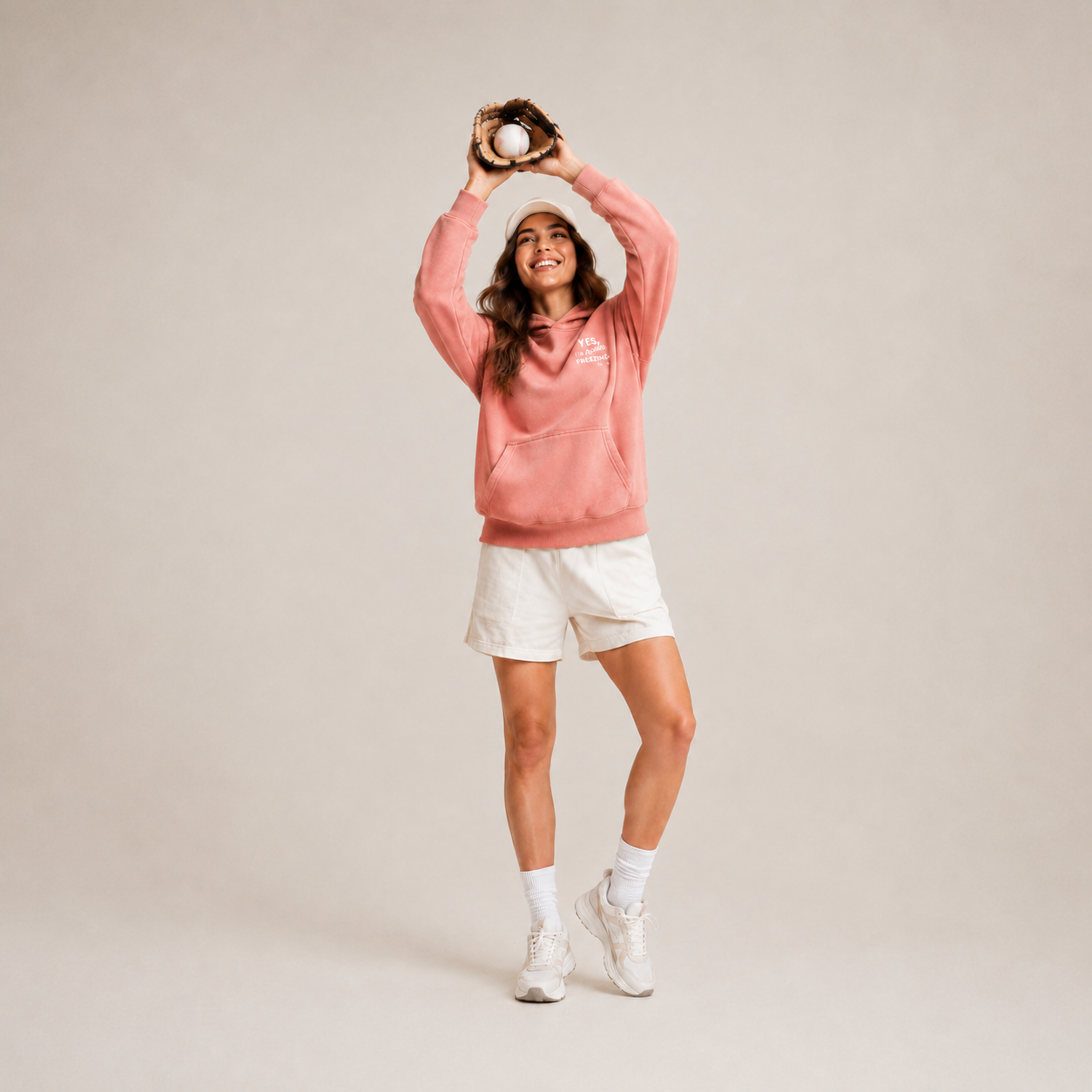 Coral pink hoodie lifestyle photo with baseball