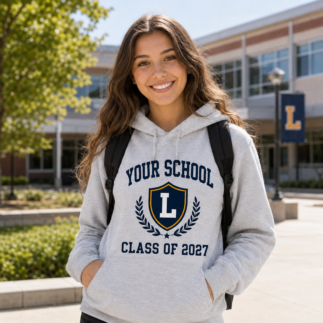 High school student wearing navy Your School Class of 2027 hoodie